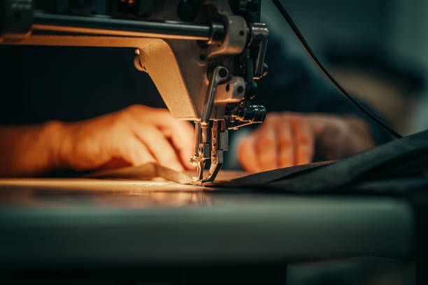 Sewing machine and men's hands of a tailor in Montenegro, RS, Brazil